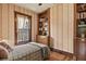 Quaint bedroom with built-in bookshelves and large window at 2716 N Vine St, Denver, CO 80205