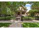 Charming home featuring a manicured lawn, iron fence, and inviting facade at 2716 N Vine St, Denver, CO 80205