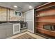 Basement kitchen featuring stainless steel appliances, grey cabinets, and access to shelving unit at 2716 N Vine St, Denver, CO 80205