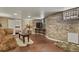 Cozy basement living room with exposed brick walls, ample space, and natural light at 2716 N Vine St, Denver, CO 80205