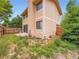 Exterior view of the home, showcasing the back yard, fence, and siding at 4032 S Atchison Way, Aurora, CO 80014