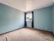Comfortable bedroom with soft carpet, serene blue walls, and a window for natural light at 4032 S Atchison Way, Aurora, CO 80014