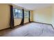 Bright bedroom with large windows, neutral carpet, and a view of the outdoors at 4032 S Atchison Way, Aurora, CO 80014
