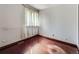 Bedroom with hardwood floors, bright natural light, and neutral-colored walls at 4032 S Atchison Way, Aurora, CO 80014