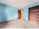 A cozy bedroom featuring blue walls, a connecting door, and a functional closet at 4032 S Atchison Way, Aurora, CO 80014
