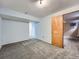 A clean, carpeted bedroom with light blue walls and a wood door leading to another room at 4032 S Atchison Way, Aurora, CO 80014