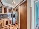 Well-equipped kitchen featuring stainless steel refrigerator and custom cabinets with granite counters at 4032 S Atchison Way, Aurora, CO 80014
