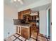 Open concept kitchen featuring a breakfast bar, custom cabinets and stainless steel appliances at 4032 S Atchison Way, Aurora, CO 80014