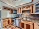 Stylish kitchen featuring custom wood cabinets, stainless steel appliances and granite countertops at 4032 S Atchison Way, Aurora, CO 80014