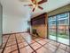 Bright living room with tile floors, brick fireplace, and sliding door to backyard at 4032 S Atchison Way, Aurora, CO 80014