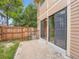 Private patio area with sliding doors, wood fence, and access to the backyard at 4032 S Atchison Way, Aurora, CO 80014