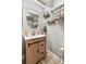 This cozy bathroom has a round mirror over the wooden vanity and marble shower walls at 8160 Washington St # 67, Denver, CO 80229