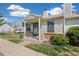 Charming home exterior with a covered porch, well-maintained landscaping, and lovely curb appeal at 8160 Washington St # 67, Denver, CO 80229