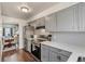 Updated kitchen features stainless steel refrigerator, range, grey cabinets and hardwood floors at 8160 Washington St # 67, Denver, CO 80229