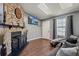 View of living room with stone fireplace and television at 8160 Washington St # 67, Denver, CO 80229