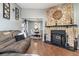Living room with stone fireplace, skylight, and view into dining area at 8160 Washington St # 67, Denver, CO 80229
