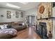 Living room with stone fireplace, skylight, and view into dining area at 8160 Washington St # 67, Denver, CO 80229