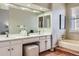 Bright bathroom featuring a bathtub, double sinks, and vanity area at 8834 Blue Mountain Pl, Highlands Ranch, CO 80126