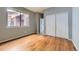 Bright bedroom with hardwood floors and sliding closet doors at 8834 Blue Mountain Pl, Highlands Ranch, CO 80126