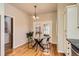 Dining area with hardwood floors, a glass table, and natural light from French doors at 8834 Blue Mountain Pl, Highlands Ranch, CO 80126