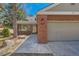 Home exterior featuring brick accents, attached garage and a walkway leading to the front door at 8834 Blue Mountain Pl, Highlands Ranch, CO 80126