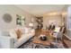 Open-concept living room seamlessly connects to the dining area, creating an inviting and spacious atmosphere at 8834 Blue Mountain Pl, Highlands Ranch, CO 80126
