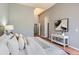 Comfortable main bedroom features a skylight, decor, wood floors, and white furnishings at 8834 Blue Mountain Pl, Highlands Ranch, CO 80126