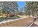 View from the deck, showing the surrounding greenery and community amenities with trees at 8834 Blue Mountain Pl, Highlands Ranch, CO 80126