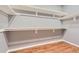Spacious walk-in closet featuring wood floors and white shelving at 8834 Blue Mountain Pl, Highlands Ranch, CO 80126