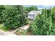 Two-story house with gray siding, surrounded by mature trees at 2456 S Marion St, Denver, CO 80210