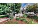 Two-story home with gray siding, blue door, and landscaped front yard at 2456 S Marion St, Denver, CO 80210