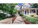 Two-story home with gray siding, blue door, and landscaped front yard at 2456 S Marion St, Denver, CO 80210