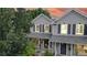 Two-story house with gray siding, navy door, and a well-manicured lawn at 2456 S Marion St, Denver, CO 80210