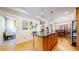 Kitchen with island, stainless steel appliances, and views into dining area at 2456 S Marion St, Denver, CO 80210