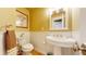 Stylish powder room with pedestal sink and beadboard wainscoting at 2456 S Marion St, Denver, CO 80210