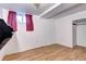 Basement offers laminate flooring, a window for natural light, and neutral colors at 3336 N Saint Paul St, Denver, CO 80205