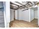 Spacious basement with light laminate flooring, exposed ceiling beams, and access to storage at 3336 N Saint Paul St, Denver, CO 80205