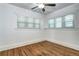 Sun-filled bedroom with hardwood floors, neutral walls, a ceiling fan, and natural light from large windows at 3336 N Saint Paul St, Denver, CO 80205