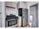 Well-lit kitchen features stainless steel appliances, light cabinets, and access to the back entrance at 3336 N Saint Paul St, Denver, CO 80205