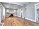 Living room boasts original hardwood floors, fireplace, natural light, and arched entryway to the kitchen at 3336 N Saint Paul St, Denver, CO 80205