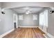 Bright living room with hardwood floors, ceiling fan, and arched entryway to the kitchen at 3336 N Saint Paul St, Denver, CO 80205