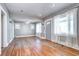 Living room showcasing original hardwood floors, ceiling fan, neutral walls, and front entrance at 3336 N Saint Paul St, Denver, CO 80205