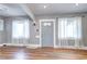 Bright living room featuring hardwood floors, fresh paint, and natural light from two windows at 3336 N Saint Paul St, Denver, CO 80205