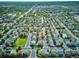 Aerial view of a community with landscaped yards, green spaces, and a community pool near the Denver Tech Center at 1169 S Alton Ct, Denver, CO 80247
