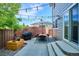 Outdoor patio with dining set, grill, and string lights perfect for entertaining at 1169 S Alton Ct, Denver, CO 80247