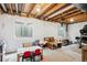Unfinished basement with painted walls, exposed ceiling, and plenty of room for storage or activities at 1169 S Alton Ct, Denver, CO 80247