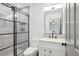 Stylish bathroom features a glass-enclosed shower, modern fixtures, and white tile at 1169 S Alton Ct, Denver, CO 80247