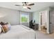 Comfortable bedroom with a large window, ceiling fan, and adjacent bathroom access at 1169 S Alton Ct, Denver, CO 80247