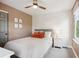 Bright bedroom features a neutral wall, a ceiling fan, and a comfortable full bed at 1169 S Alton Ct, Denver, CO 80247
