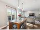 Open dining area with a wooden table, pendant lights, and access to an outdoor patio at 1169 S Alton Ct, Denver, CO 80247